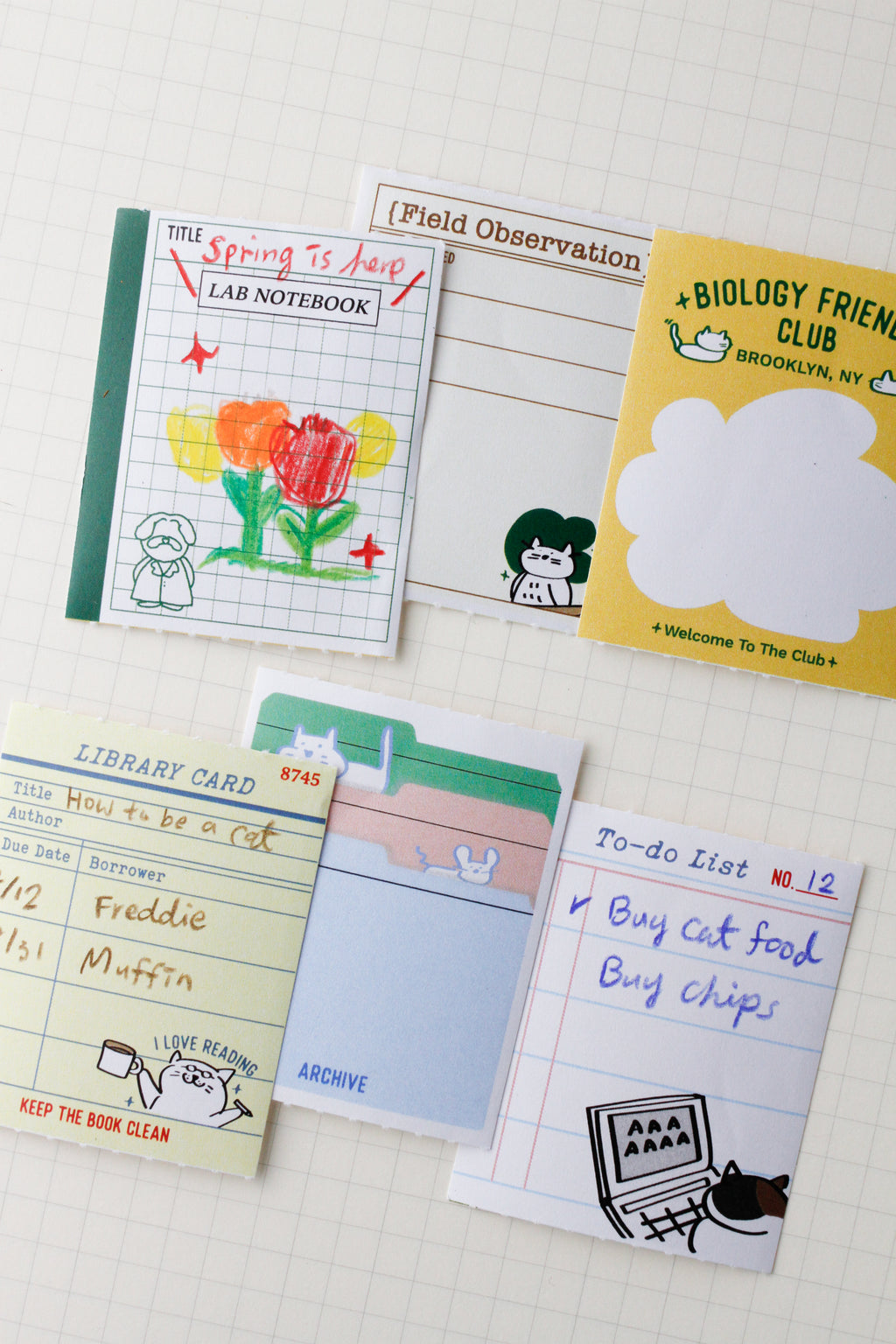 Collection of small notebooks sticky notes and to-do lists on a textured surface